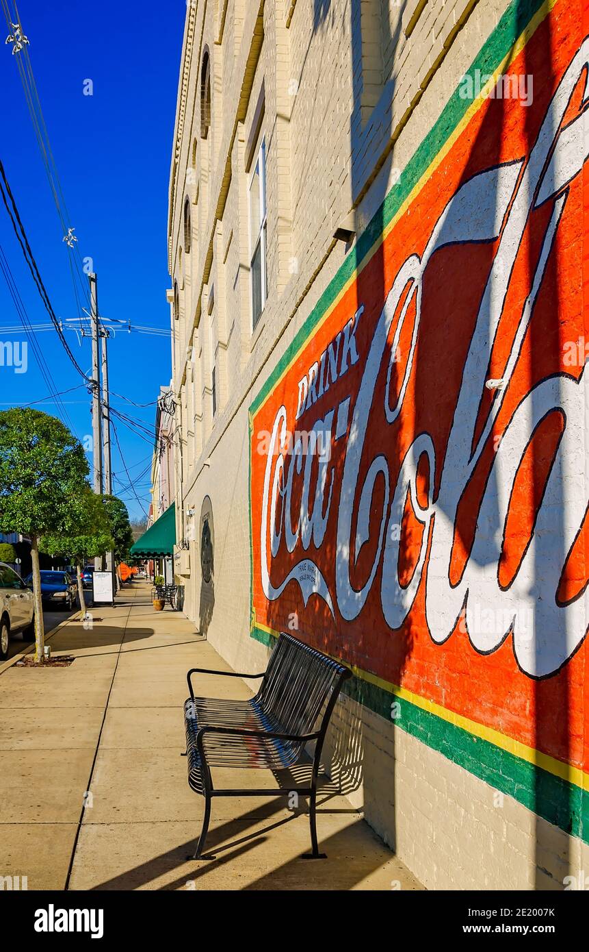 A Coca-Cola mural adorns the wall of a business as the sun sets in downtown Corinth, Mississippi. Corinth Coca-Cola Bottleworks was founded in 1907. Stock Photo
