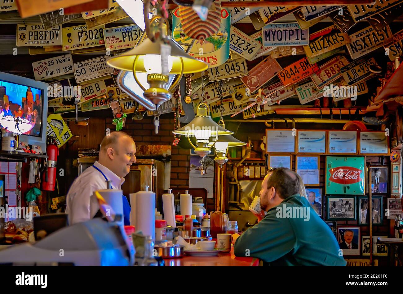 Ryan Whitfield talks to customers at Abe's Grill in Corinth, Mississippi March 5, 2012. Stock Photo