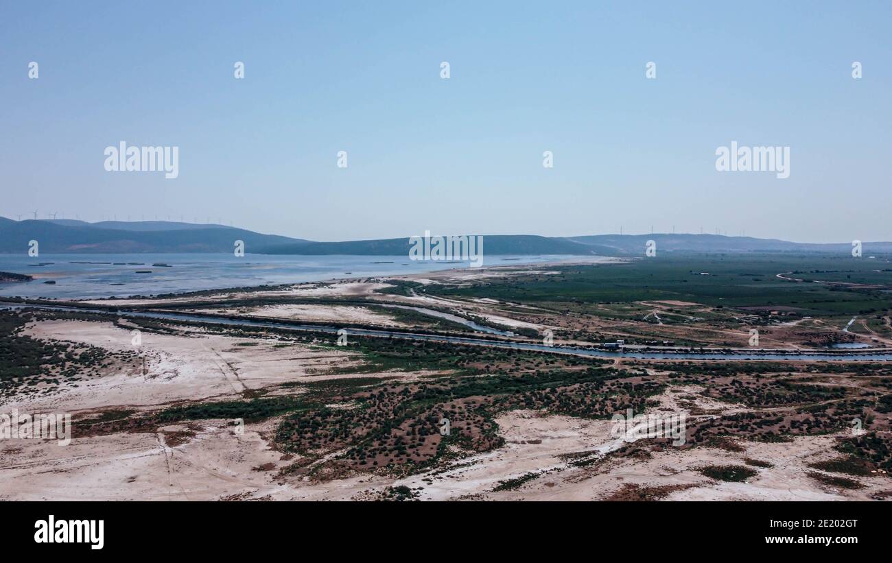aerial drone shoot from side of an old lake - white sands and plain background - blue is dominant color. photo has taken at bafa lake at turkey. Stock Photo