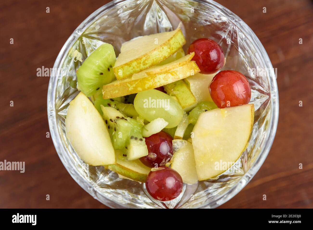 Fruit salad with tropical fruits, top view, close-up Stock Photo