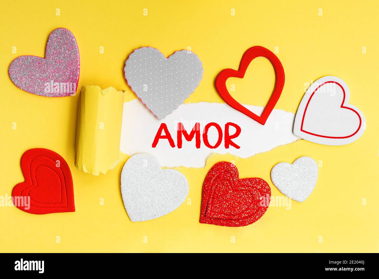 Spanish word Love written in red letters on a yellow card with love