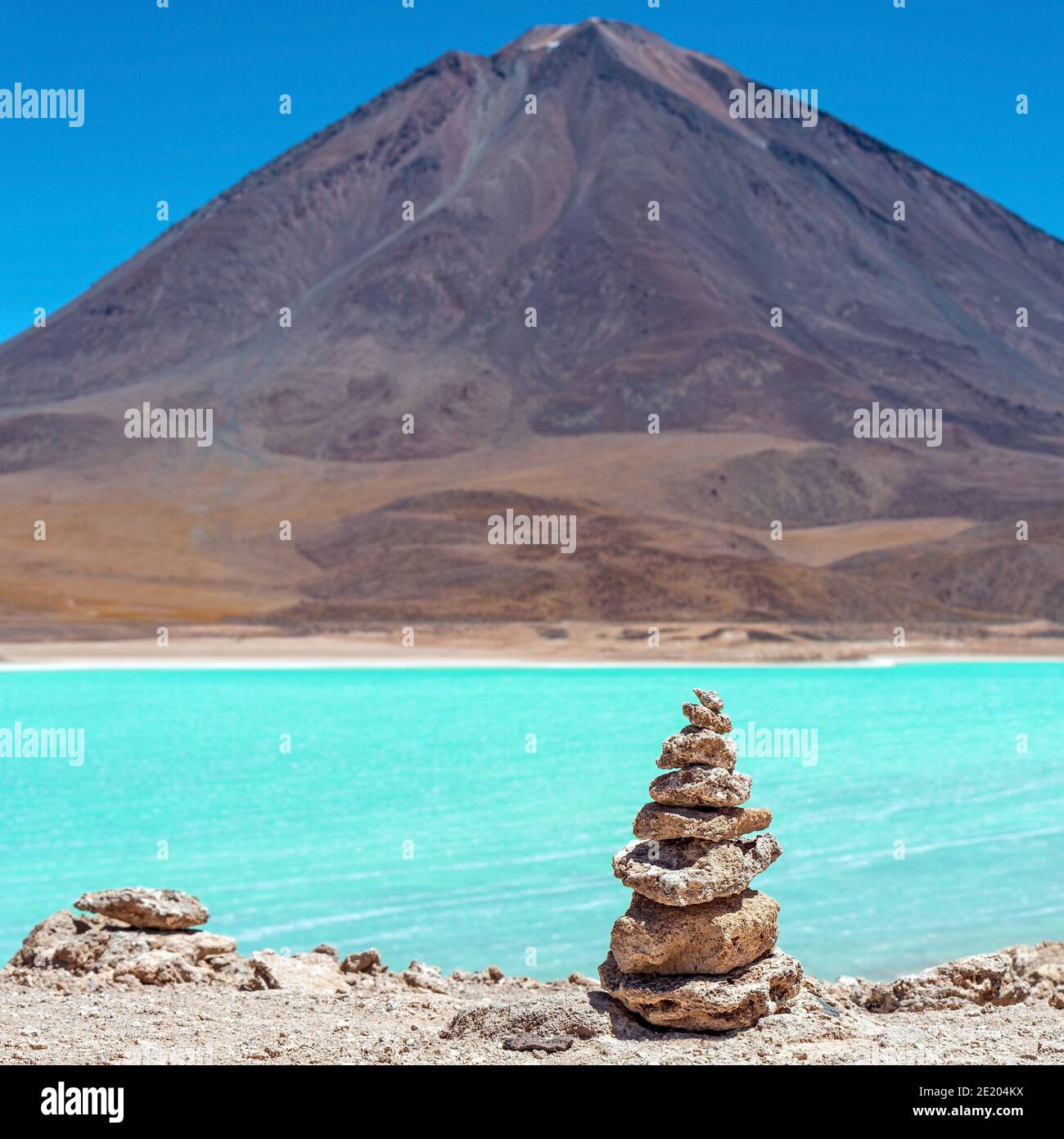 Wish pyramid by the Laguna Verde (Green Lagoon) and Licancabur volcano, Uyuni, Bolivia. Stock Photo