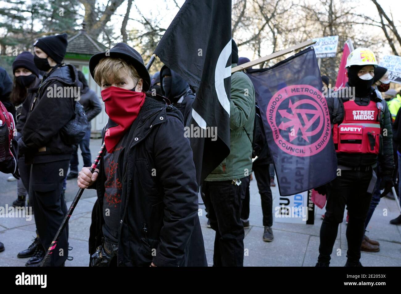 Members of an anti-fascist group in riot gear march through the streets ...