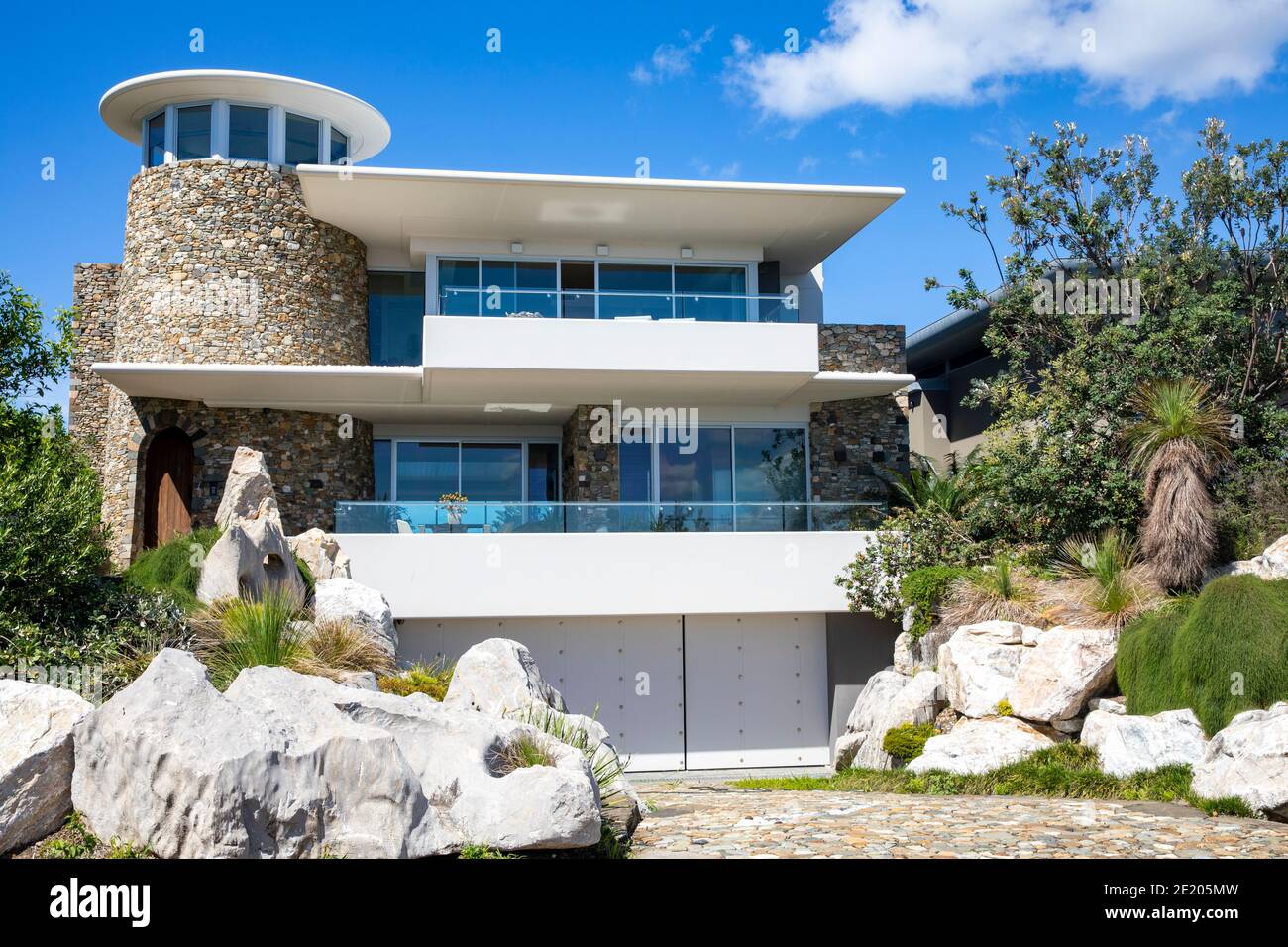 Sydney large detached coastal house in Avalon Beach with rock and green front domestic garden,Sydney,Australia Stock Photo