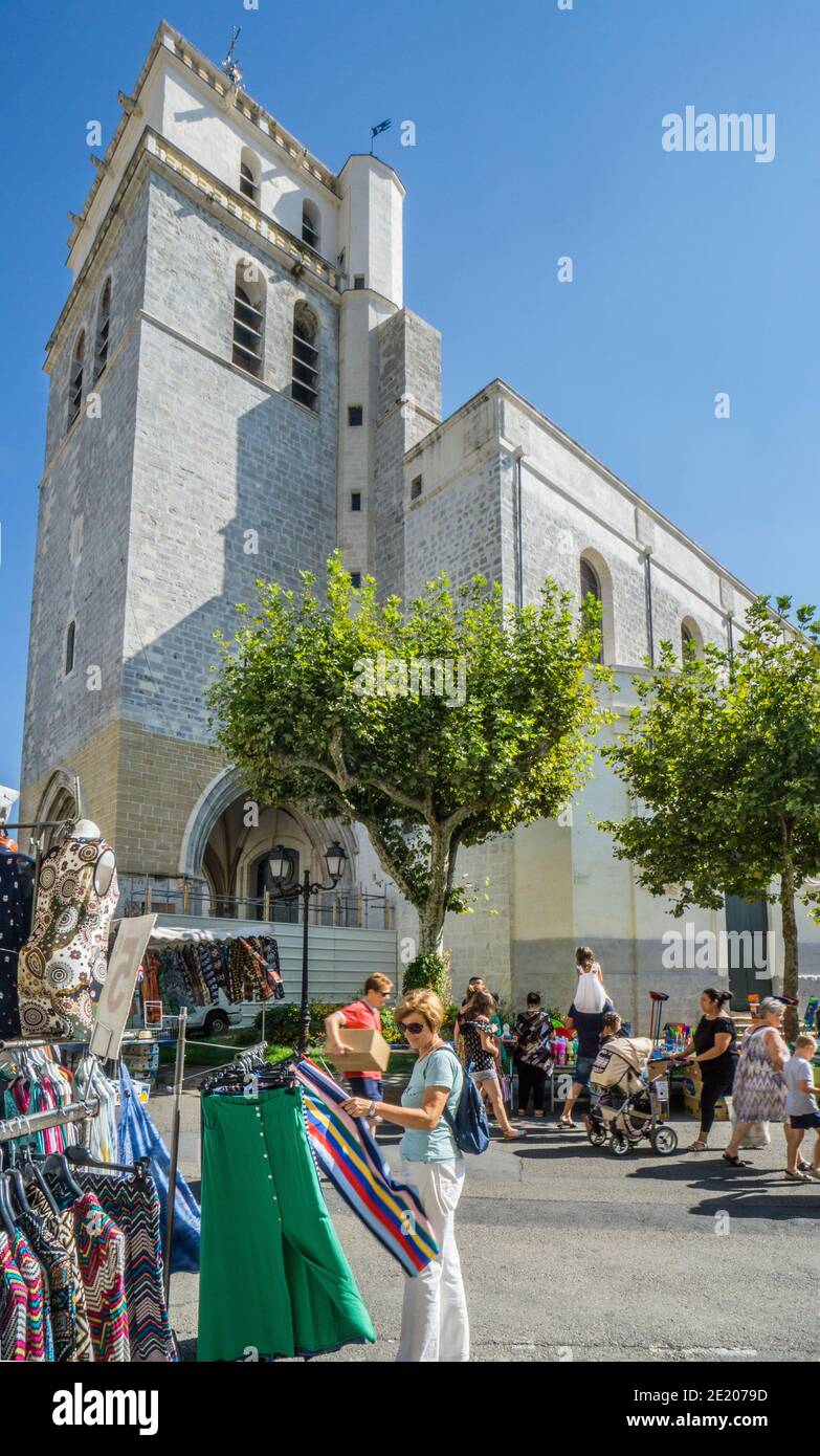 market at Place Saint-Jean in Alès against the backdrop Alès Cathedral, Gard department; Occitanie region; Southern France Stock Photo