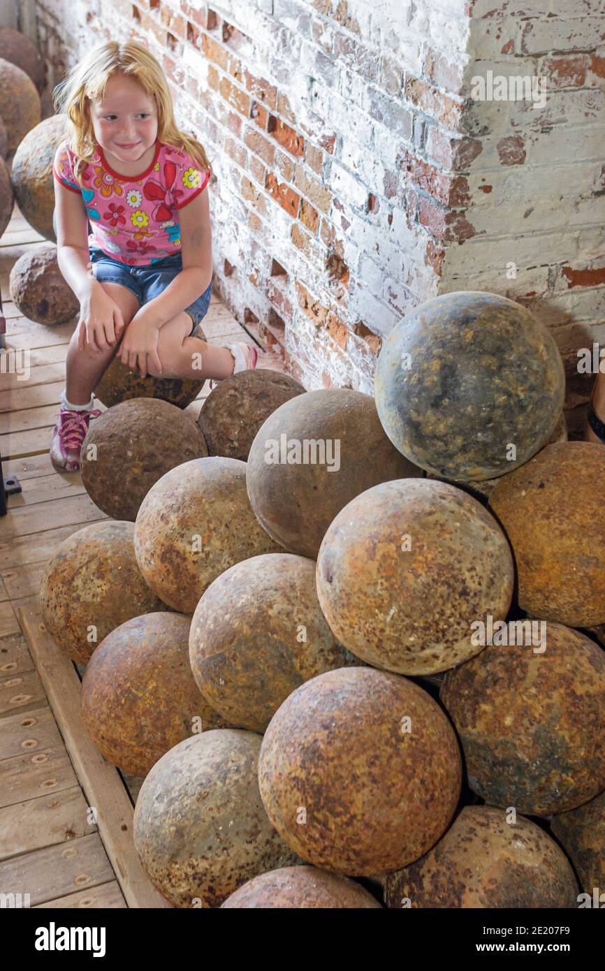 Alabama Fort Morgan 1834 historic historical girl looking looks,round shot cannonball cannonballs, Stock Photo