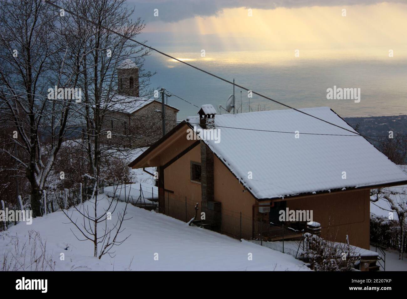 isolated village in the mountains in the Apuan Alps submerged in the white fairy snow of winter in tuscany Stock Photo