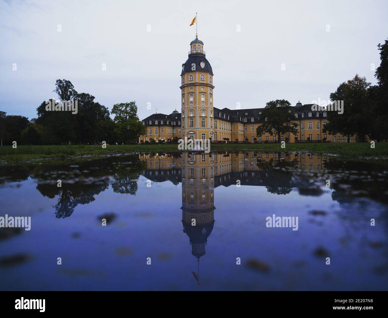 Panorama reflection of yellow stone Schloss Karlsruhe Castle Palace Schlosspark in Baden Wurttemberg Germany in Europe Stock Photo