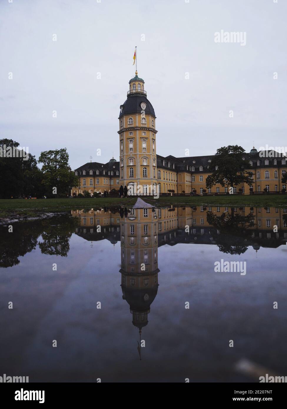 Panorama reflection of yellow stone Schloss Karlsruhe Castle Palace Schlosspark in Baden Wurttemberg Germany in Europe Stock Photo