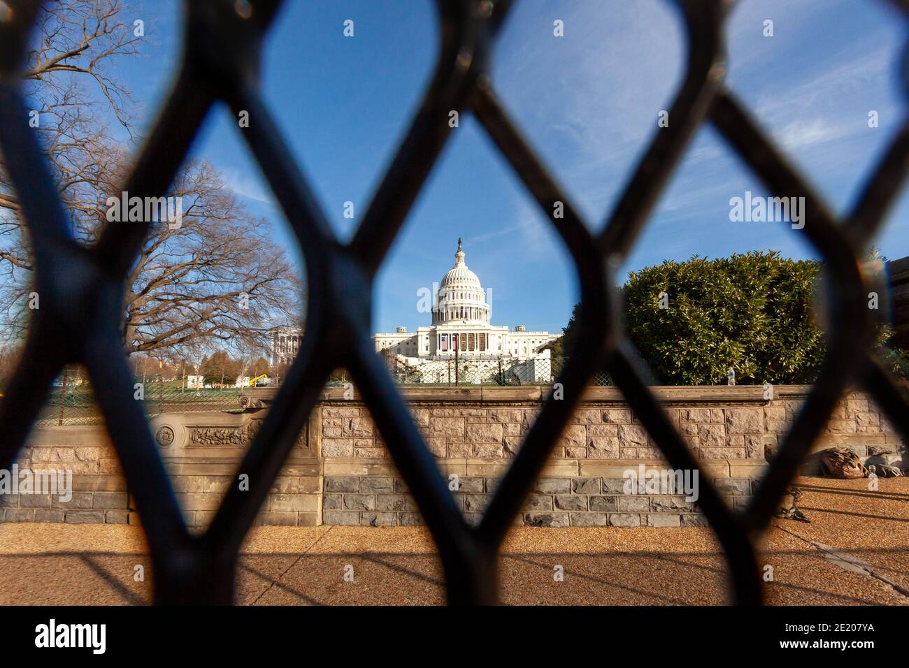 Washington, DC, USA, 10 January 2021.  Pictured:  The United States Capitol viewed through the new fence erected after the January 6 insurrection.  This photo was taken during Operation: Clean Sweep, an effort to clean up trash and propaganda left behind by fascists and Trump supporters.  It was hosted by Continue to Serve, an anti-racist organization of military veterans.  Credit: Allison C Bailey/Alamy Live News Stock Photo