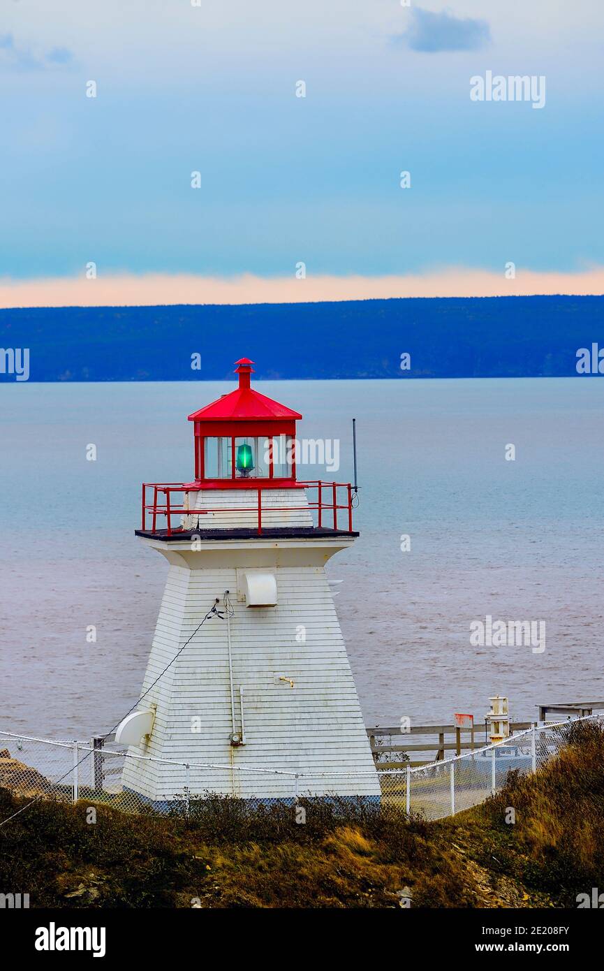 A vertical image of the Cape Enrage lighthouse in Alberta County New Brunswick on the Bay of Fundy to warn boat travelers of the rocky shore line Stock Photo