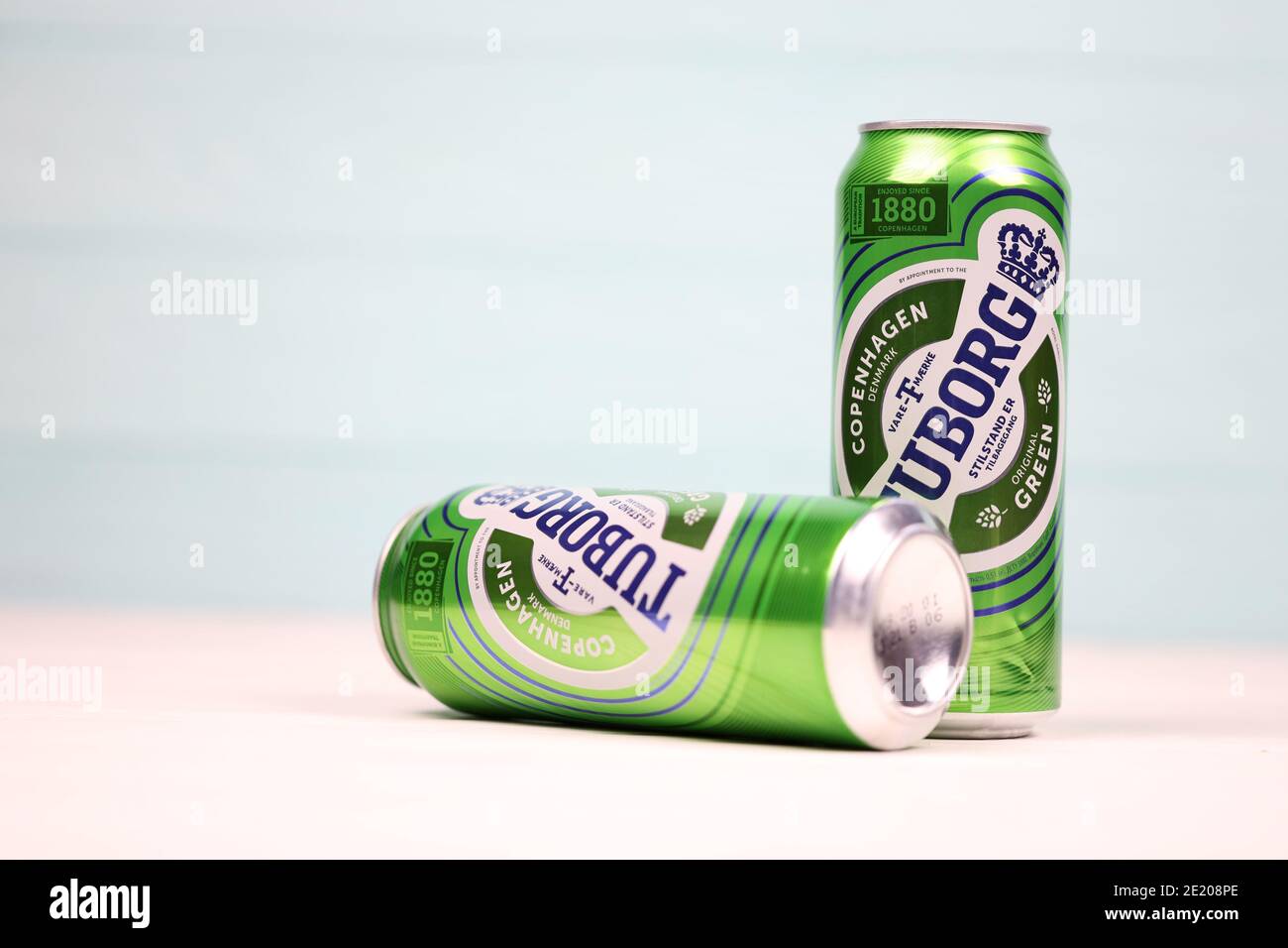 KHARKOV, UKRAINE - DECEMBER 8, 2020: Aluminium cans of green Tuborg beer on wooden background. Tuborg is a Danish brewing company founded in 1873 Stock Photo