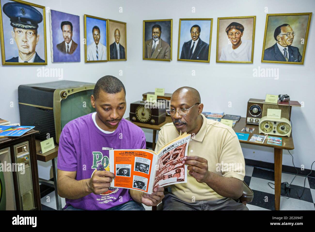 Alabama Mobile Africa Town Welcome Center centre exhibit man,Black History father adult son looking reading exhibit, Stock Photo