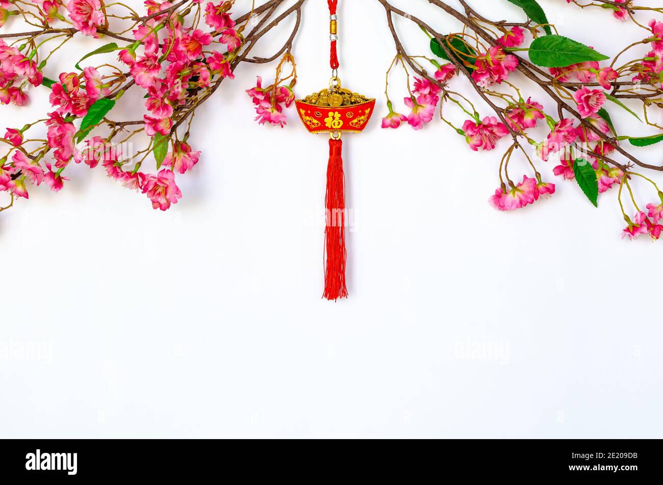 Hanging pendant for Chinese new year ornament (meaning of word is wealth)  with Chinese blossom flowers on white background Stock Photo - Alamy