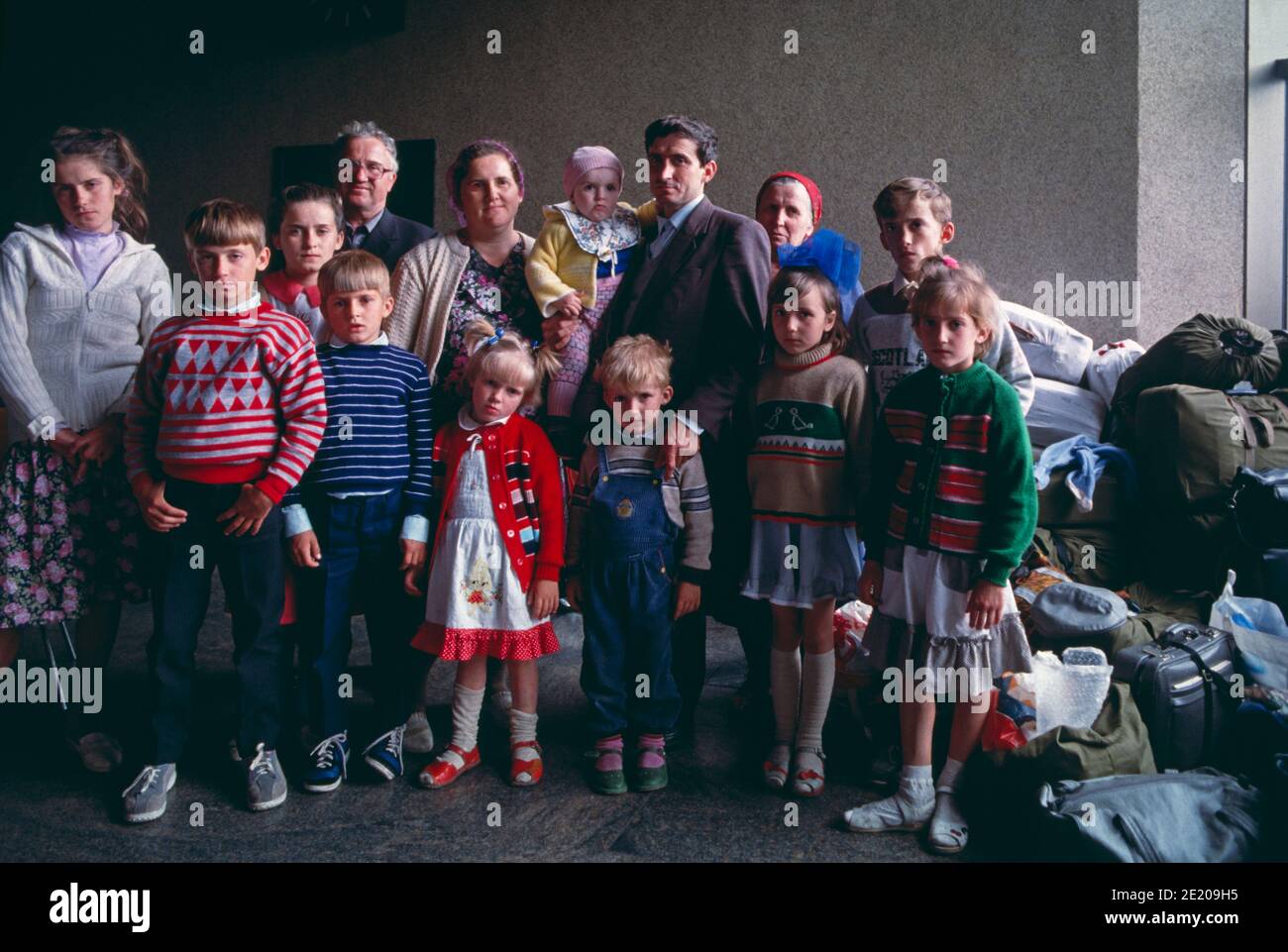 21 May 1991, Sheremetyevo International Airport, Moscow, Russia, USSR. A Russian German multigenerational family waits with their belongings inside the airport for days for their flight to Germany. Stock Photo