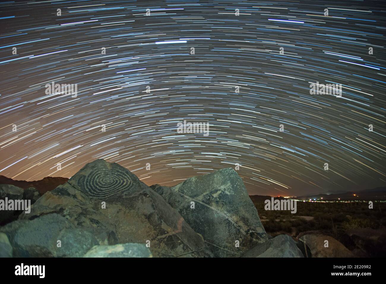 Star trails above ancient Hohokam petroglyphs Stock Photo