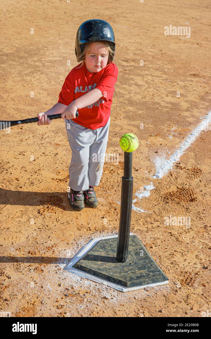 Alabama Monroeville Veterans Park little league baseball,K Ball girl batter bat ball swinging batting tee, Stock Photo