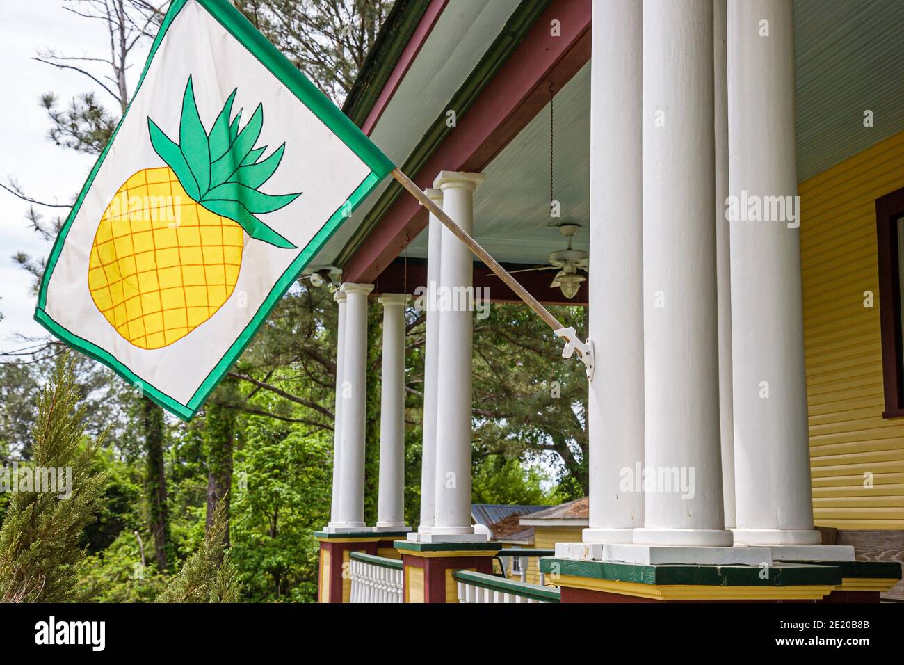 Alabama Pine Apple historic Victorian style home,banner flag pineapple porch, Stock Photo