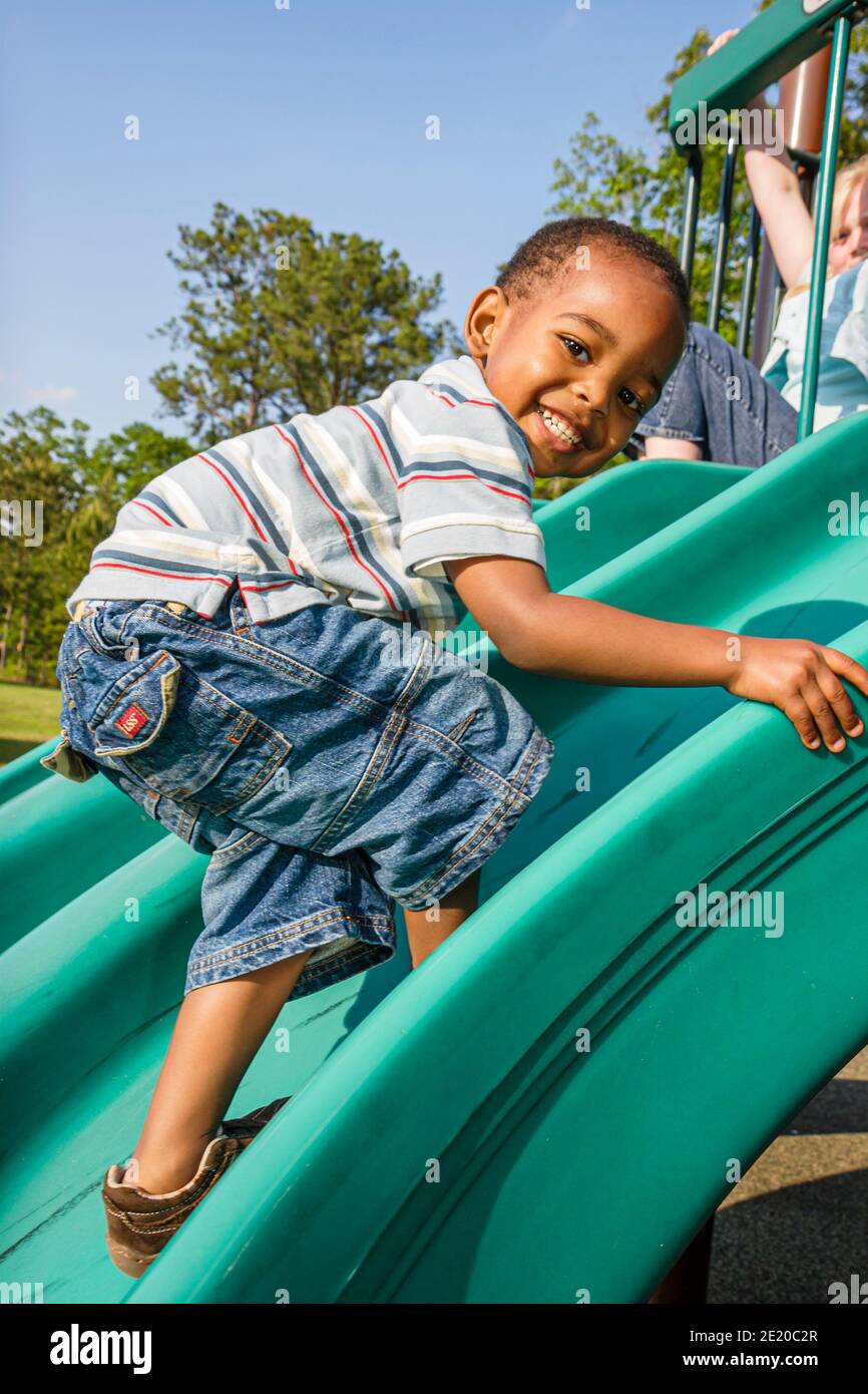 Alabama Dothan playground child children Black boy climbing slide, Stock Photo