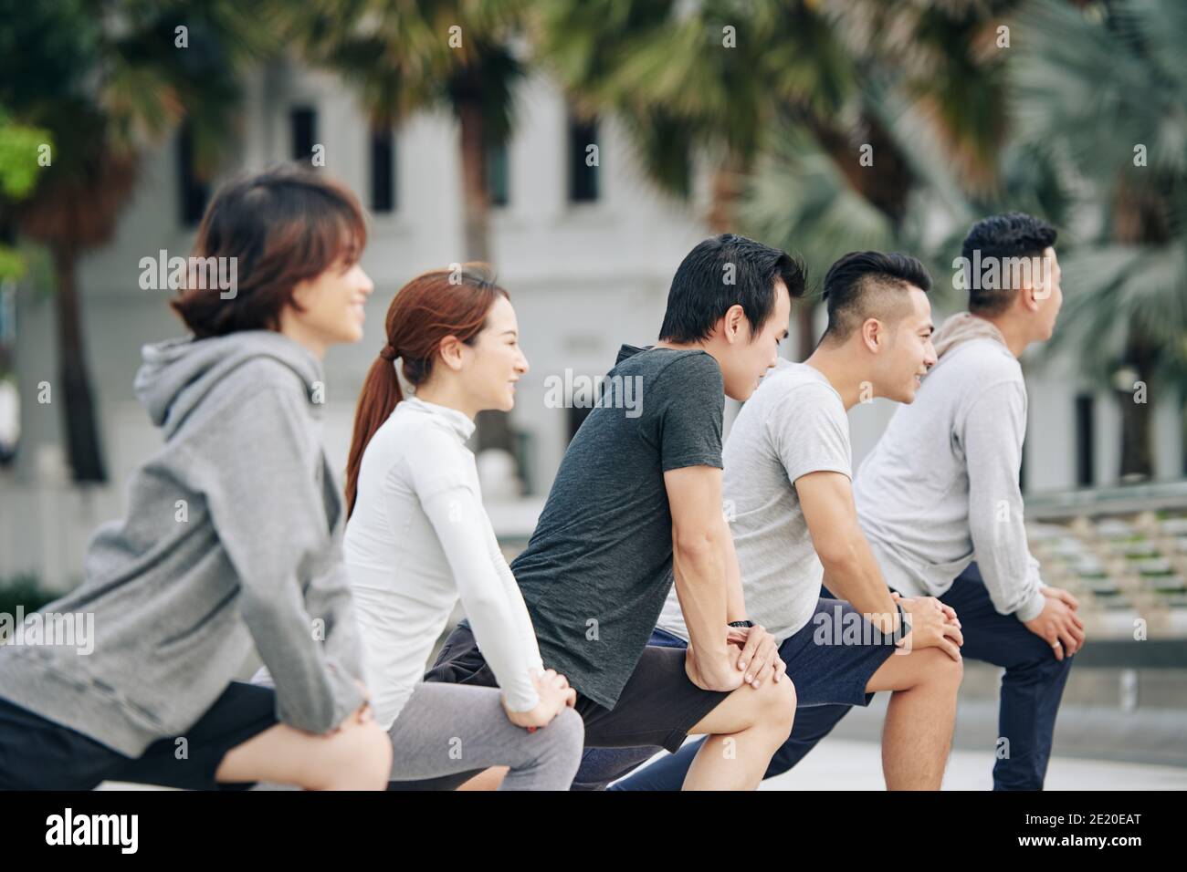 Young people doing deep lunges Stock Photo