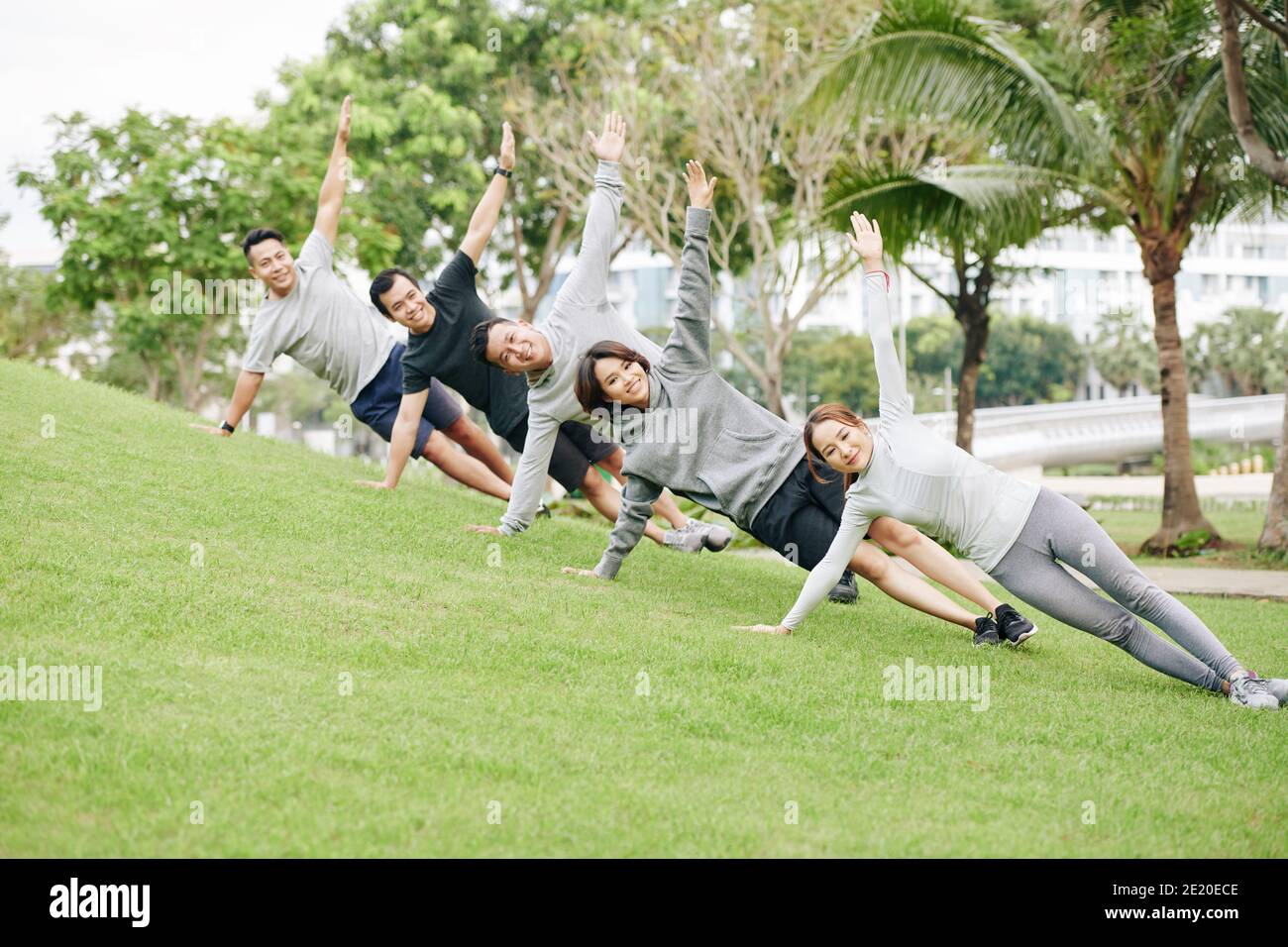 Fit young people doing side plank Stock Photo