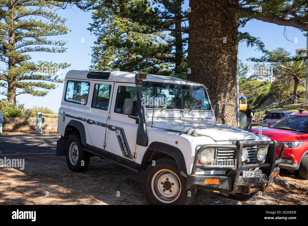 White classic Land Rover defender vehicle parked at a Sydney beach,NSW,Australia Stock Photo
