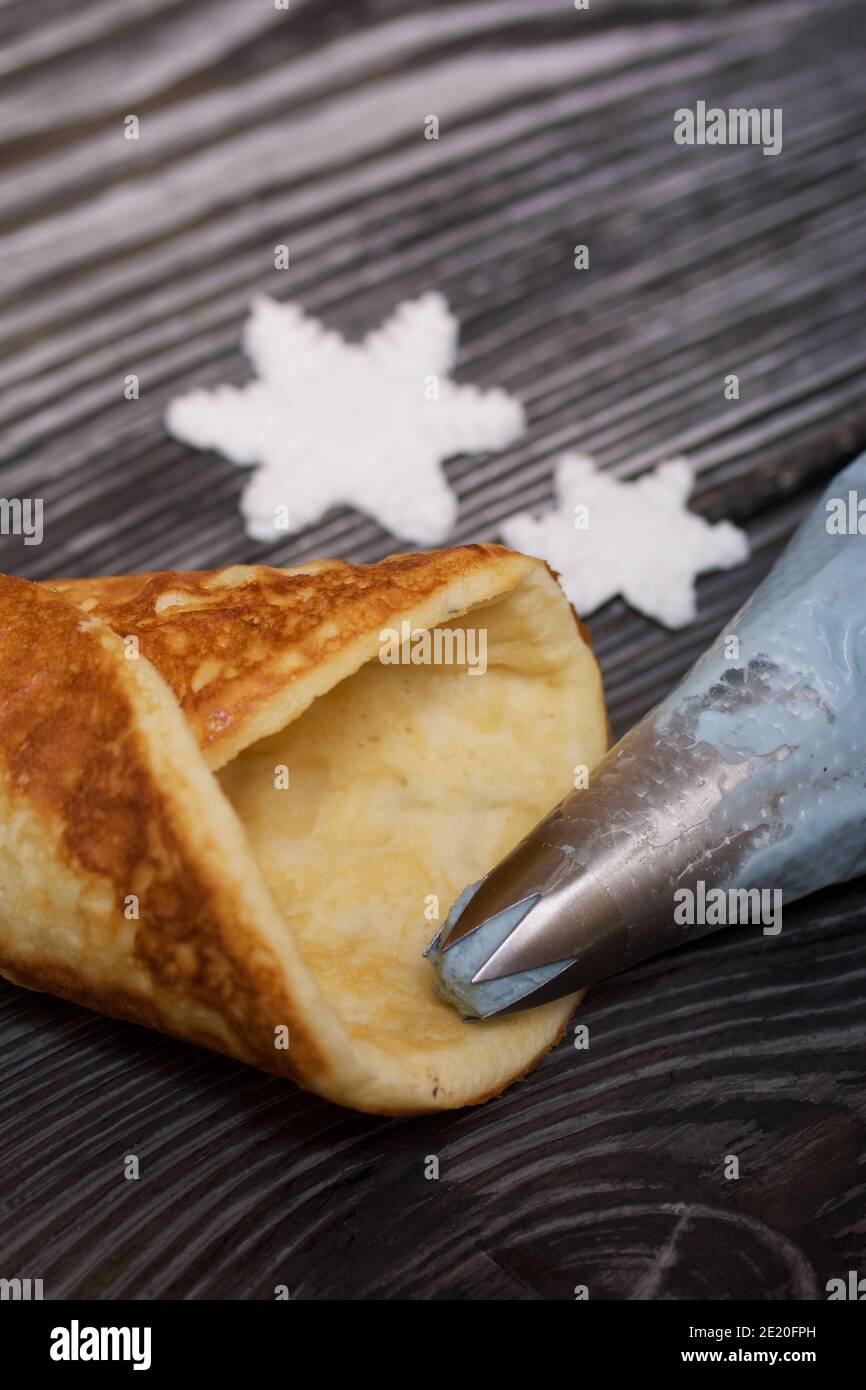Ingredients for making dessert. Cream cheese of different colors, waffle cones and chocolate. Stock Photo