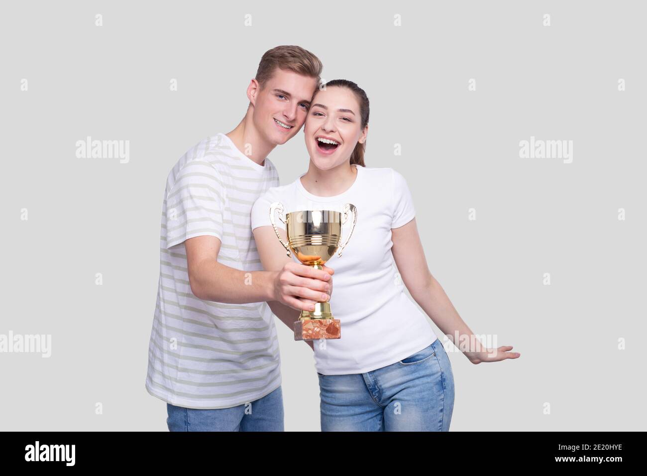Couple Holding Trophy Happy Isolated. Couple Goals. Winners Stock Photo