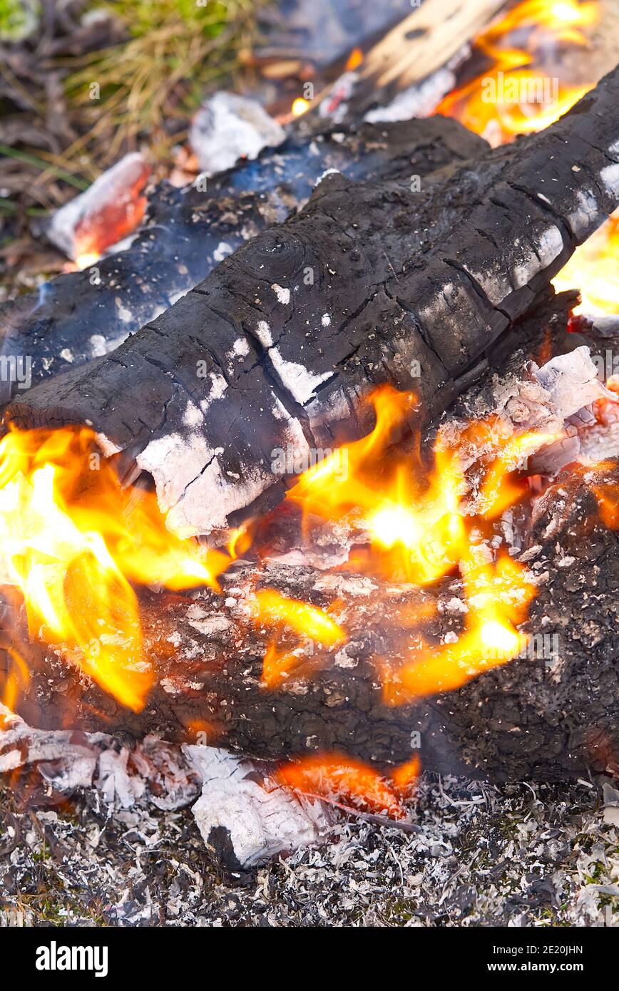 Campfire kettle closeup with blurred bonfire in the background