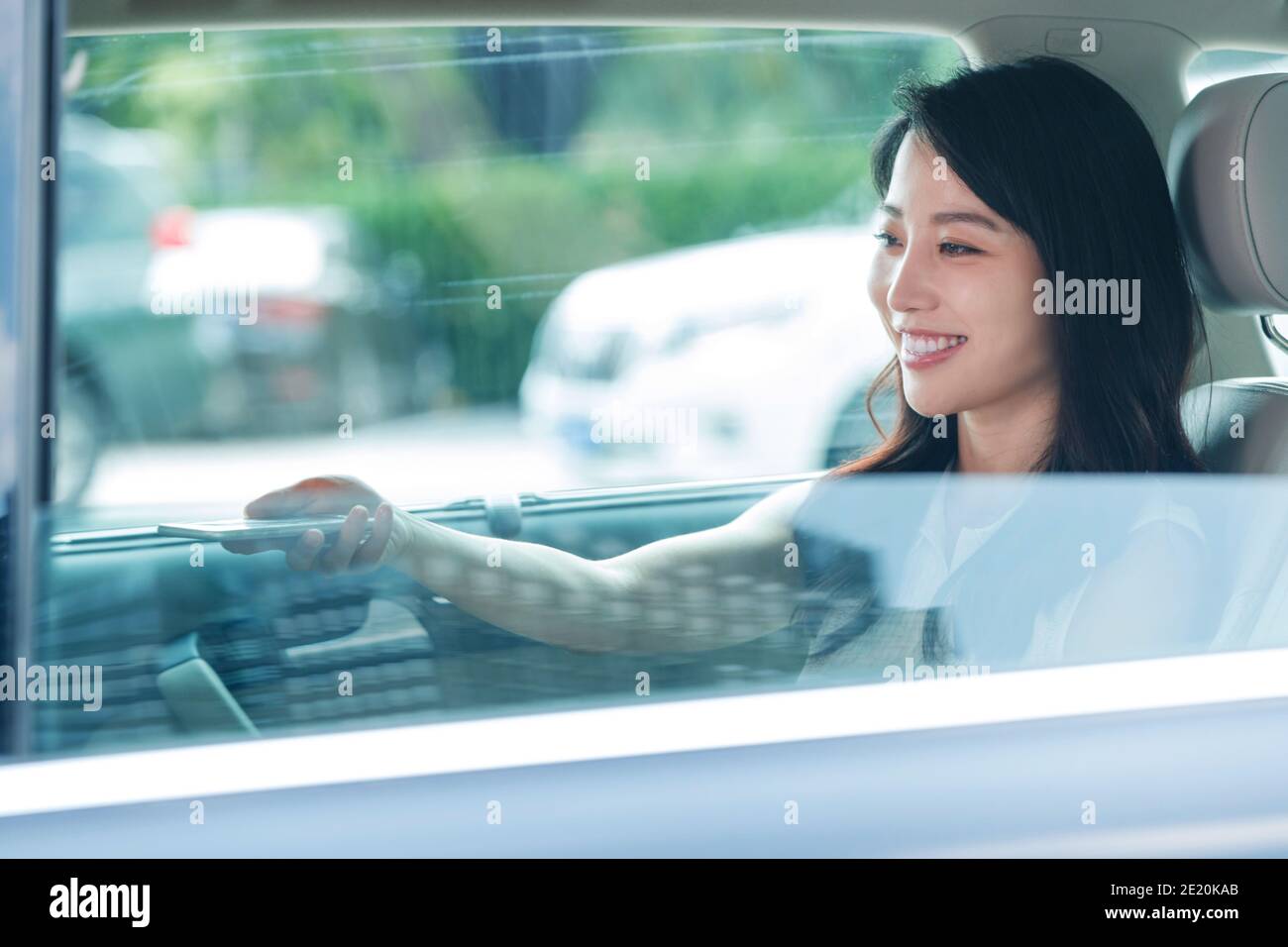 Happy young woman in the car Stock Photo - Alamy