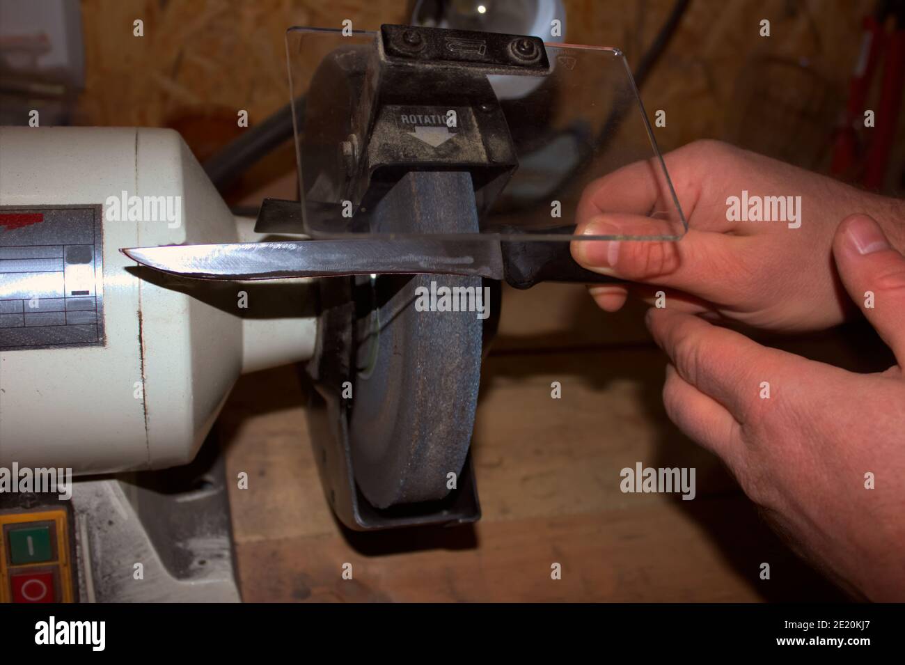 Sharpening knife on old grindstone wheel Stock Photo - Alamy