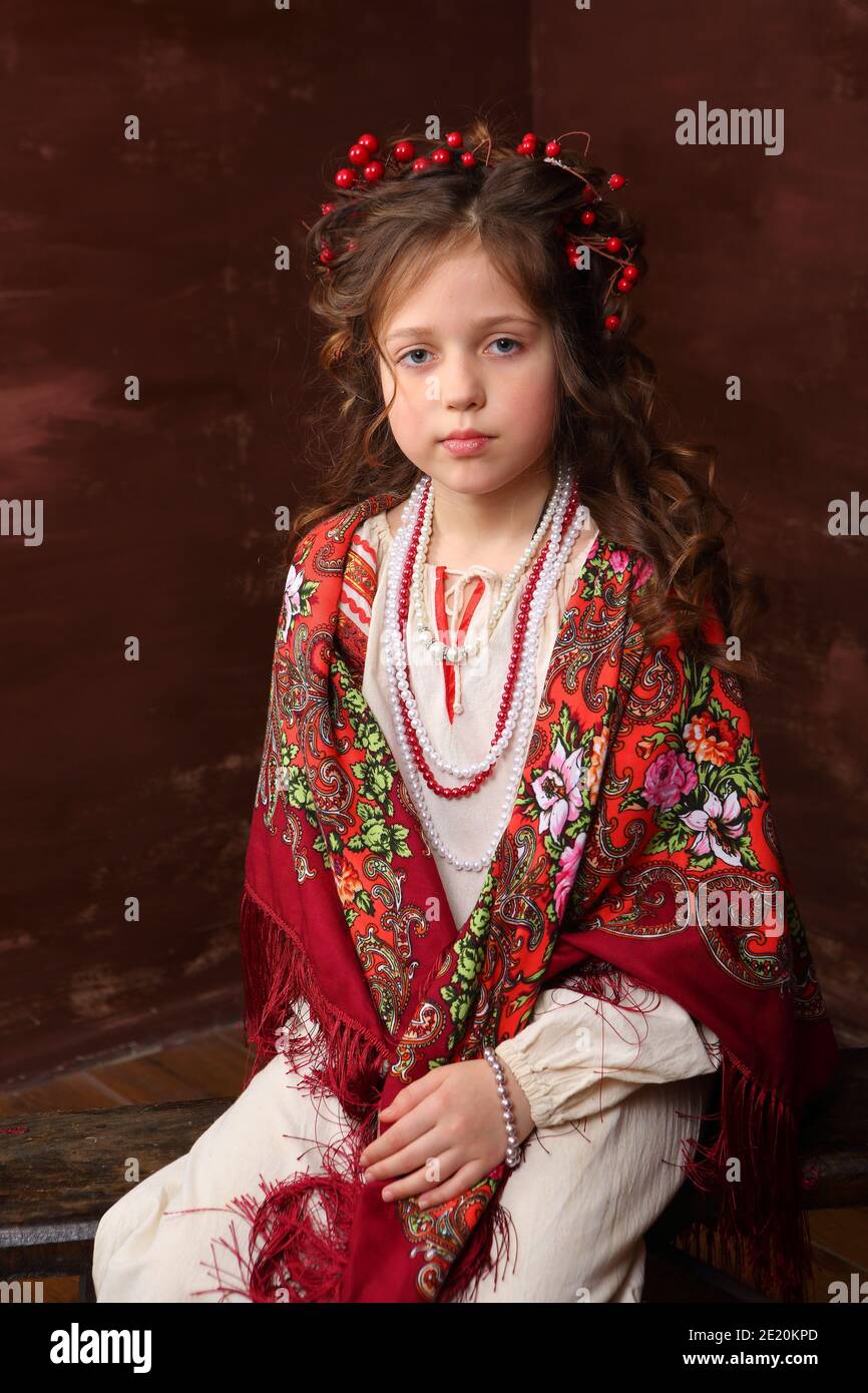 Beautiful girl with a red scarf with an ornament Stock Photo Alamy