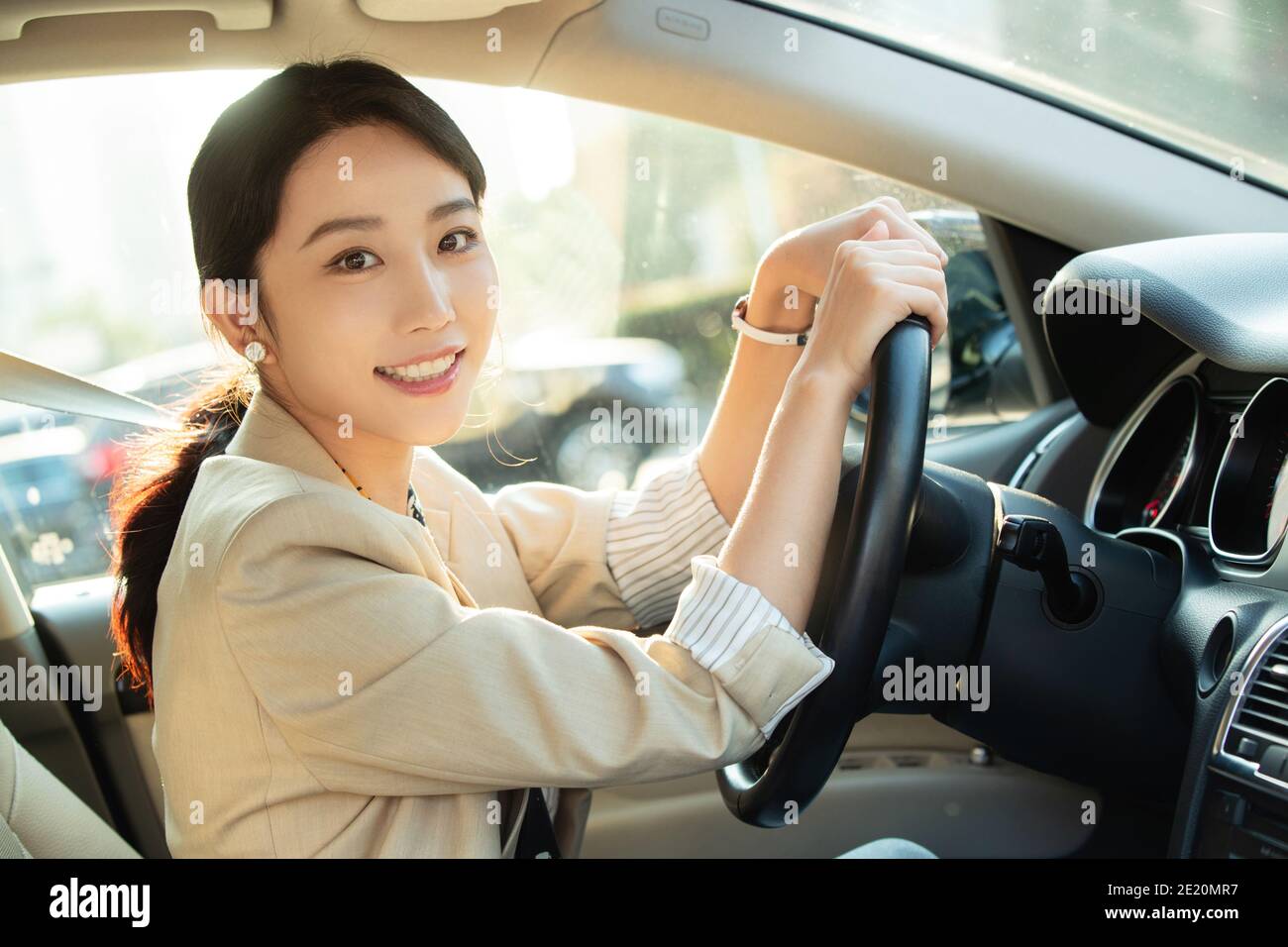 Happy young woman driving a car Stock Photo