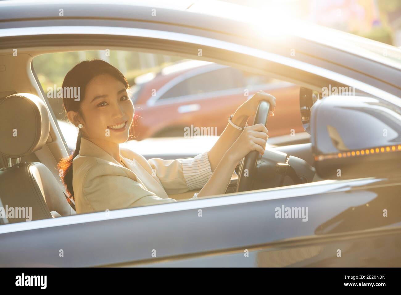 Happy young woman driving a car Stock Photo