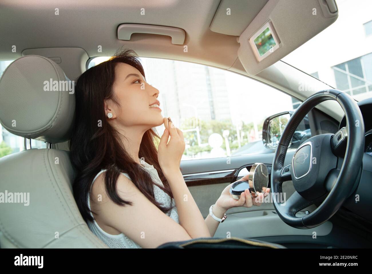 Young women makeup in the car Stock Photo