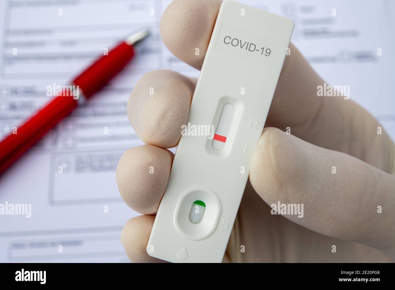 Covid-19, hand in glove and test sticks Stock Photo