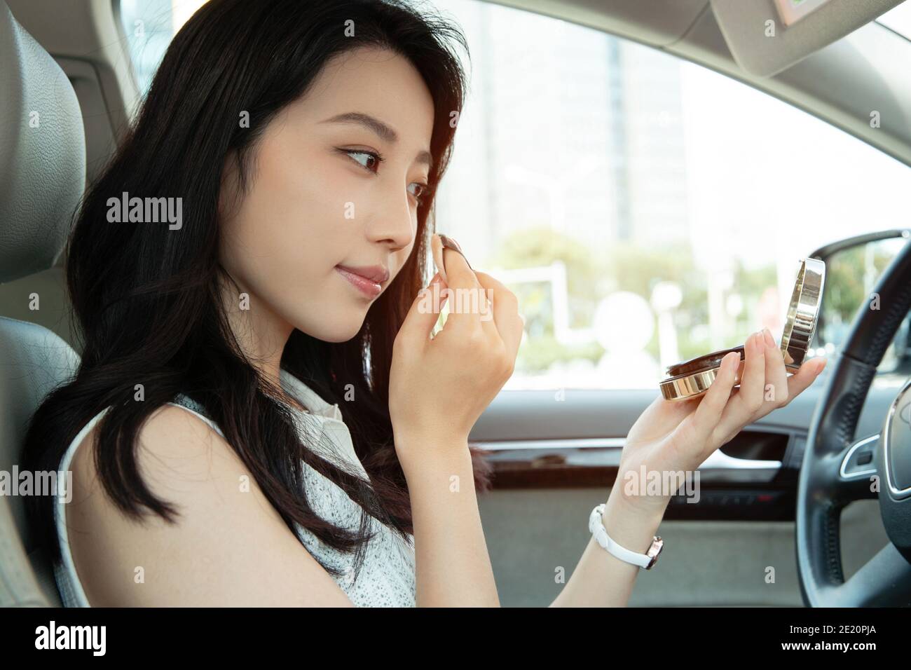 Young women makeup in the car Stock Photo