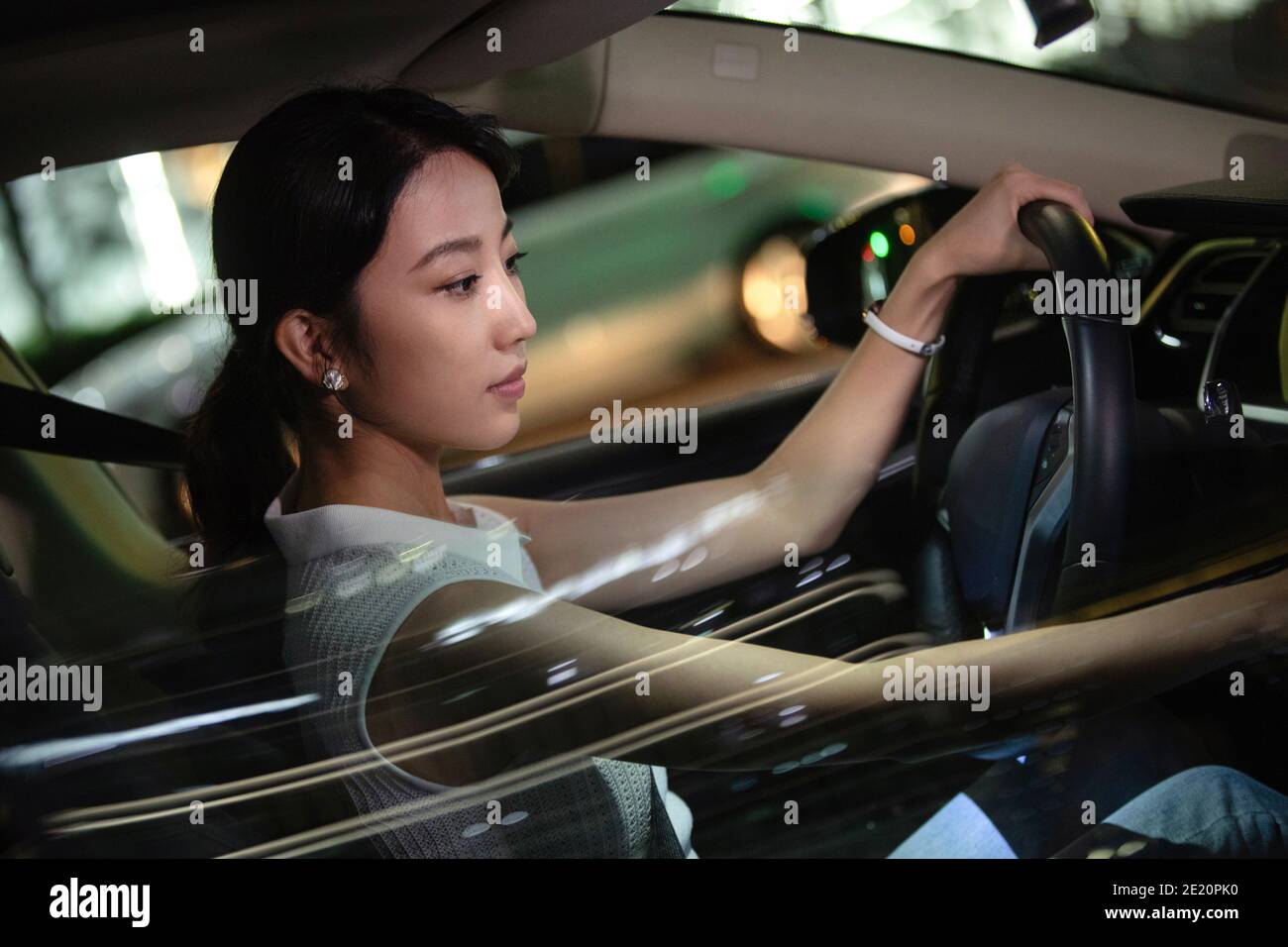 Beautiful young woman driving a car Stock Photo