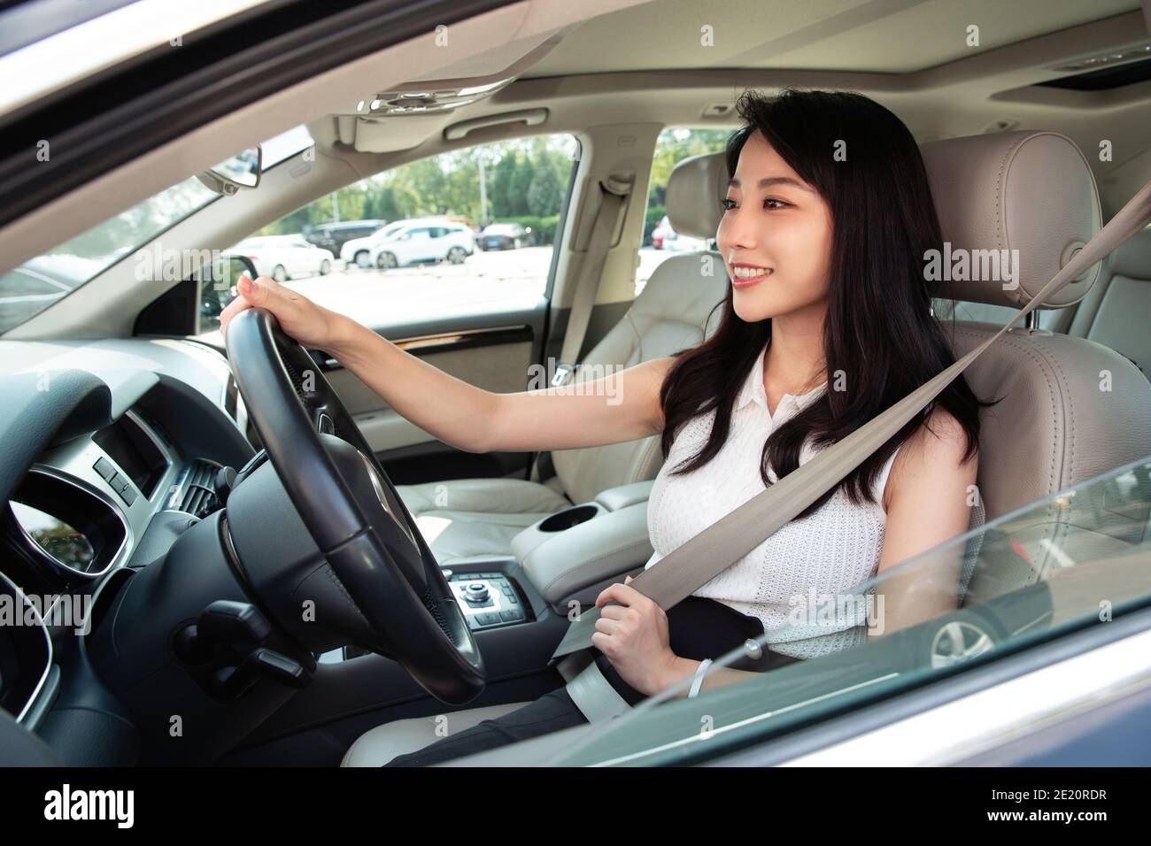 A beautiful young woman driving a car Stock Photo