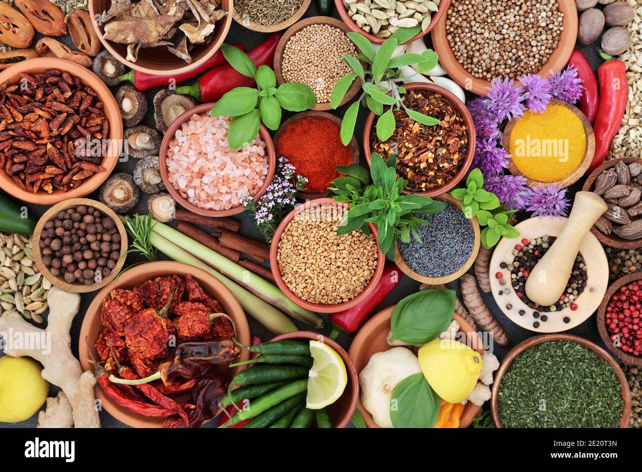 Herb and spice assortment in bowls forming a colourful abstract