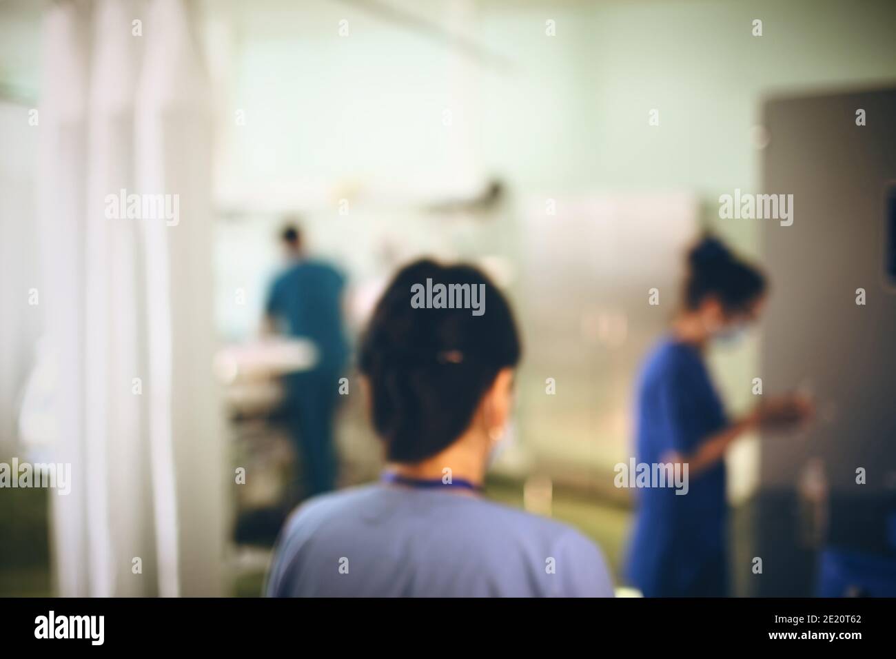 Working doctors in itensive care, unfocused background. Stock Photo