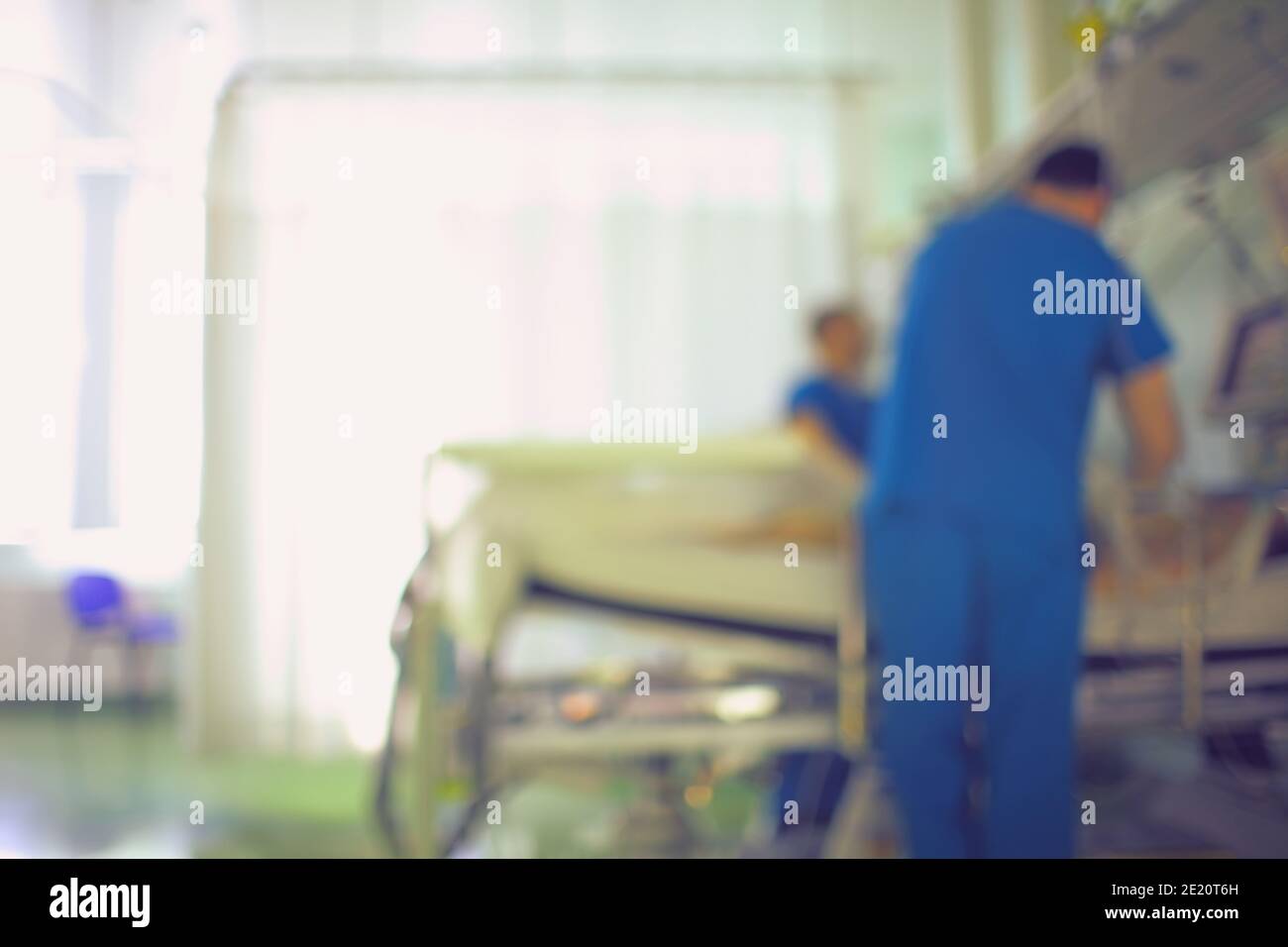 Hospital ward with doctor at the patient bed, unfocused background. Stock Photo