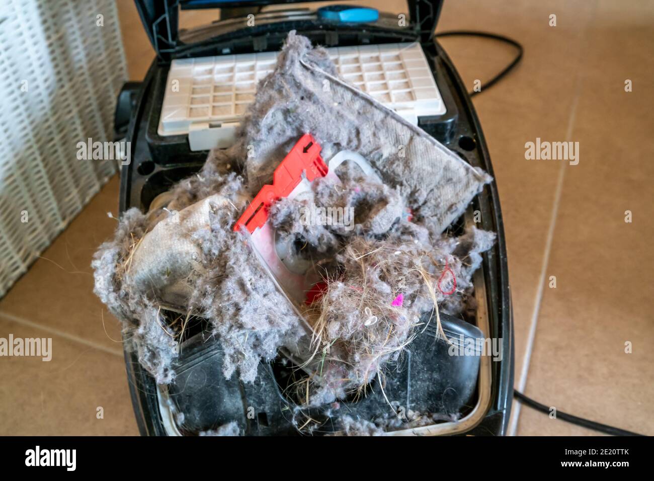 Exploded hoover dust bag producing much dirt Stock Photo Alamy