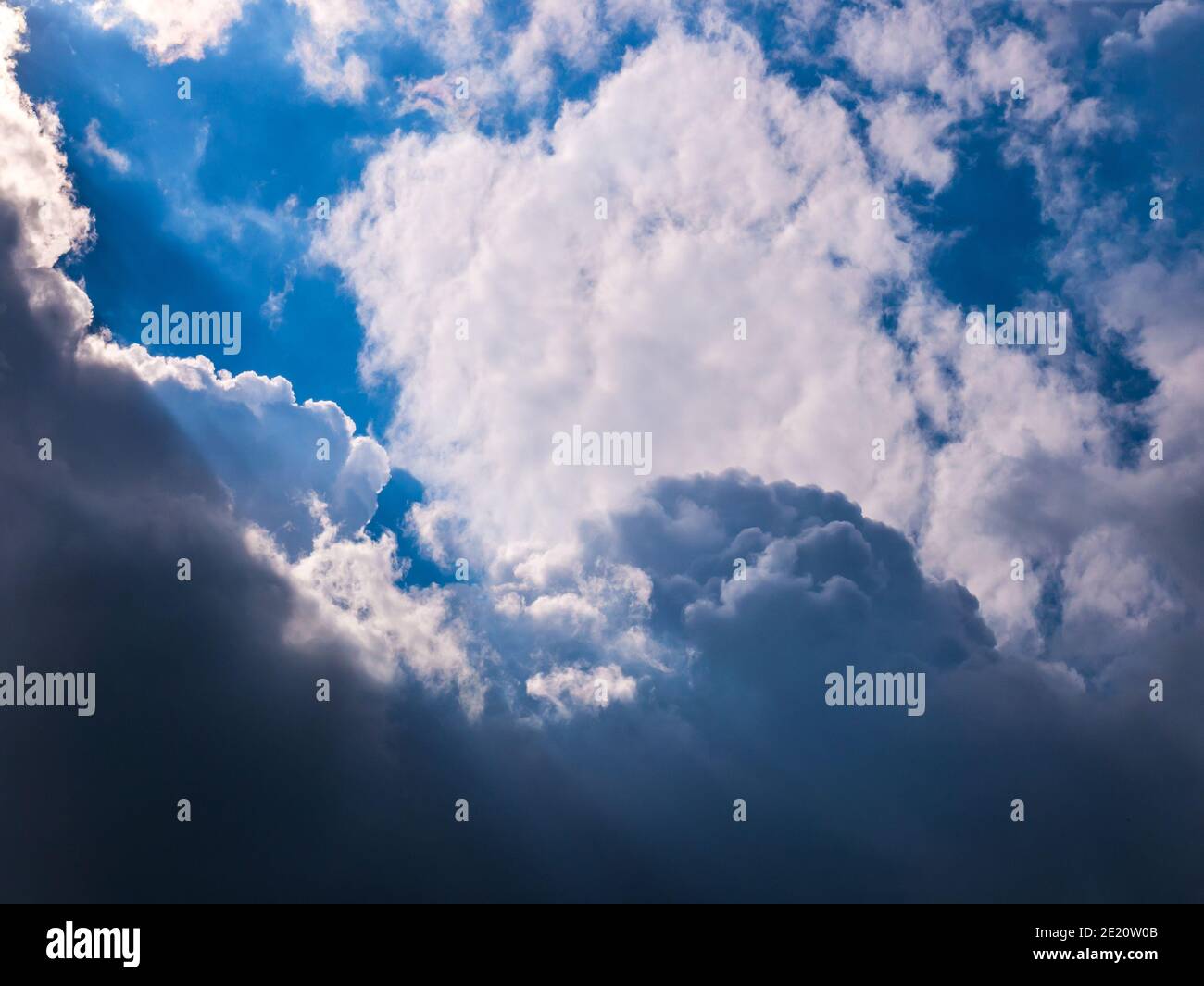 Sun rays shining through thick cloudy sky. Stock Photo
