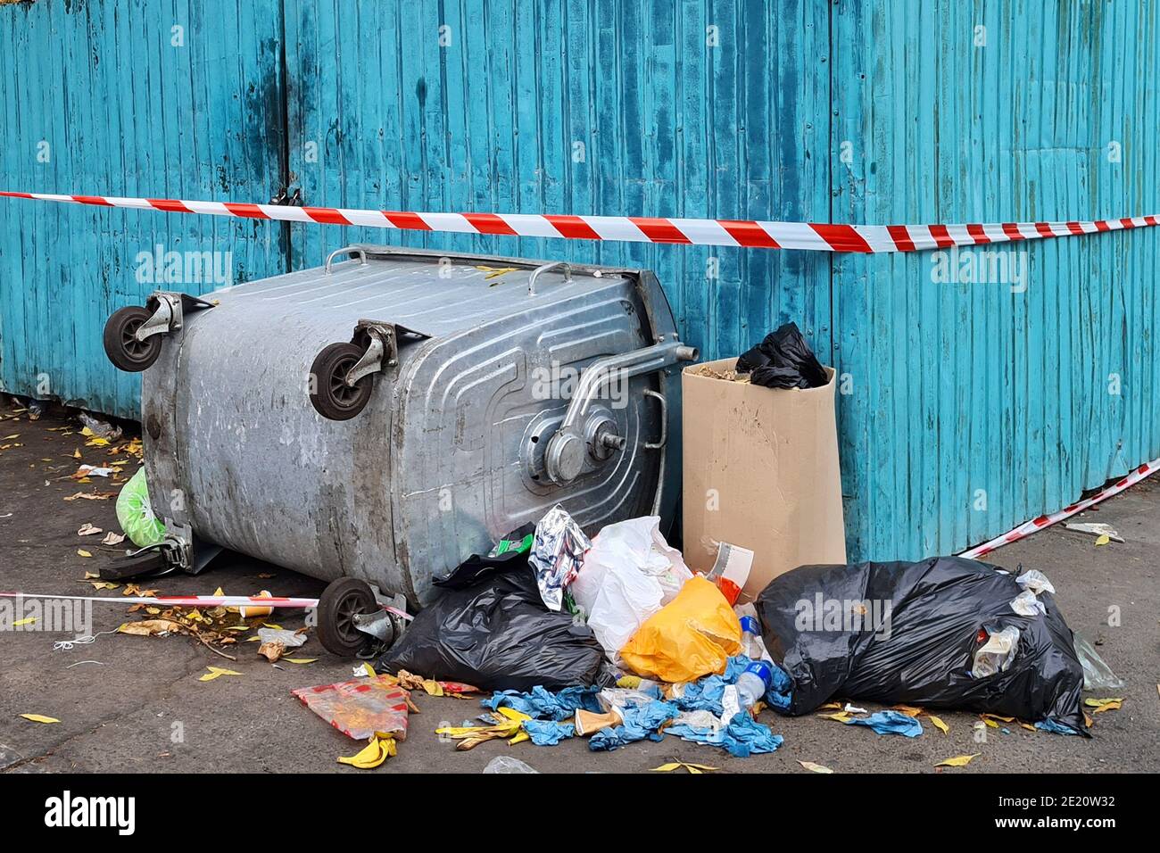 Trash in overloaded inverted garbage bins on city street. Ecological
