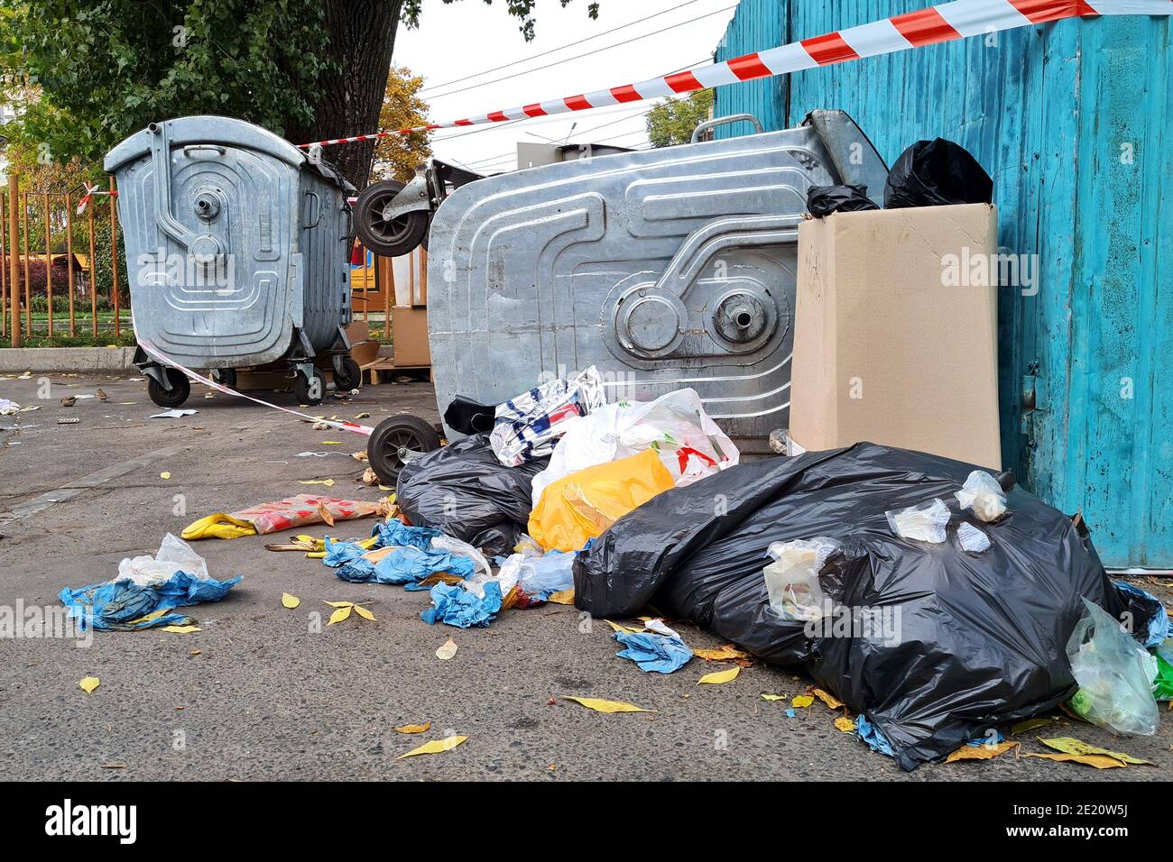Trash in overloaded inverted garbage can on city street. Ecological