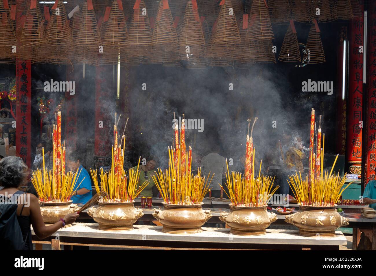 Incense burning in large pots in a Buddhist temple in Vietnam Stock Photo
