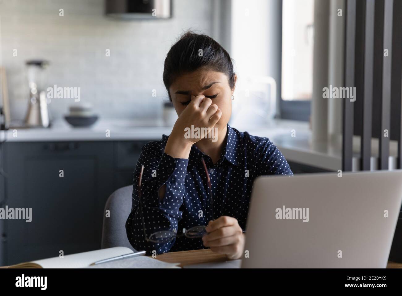 Tired Indian woman suffer from headache working on computer Stock Photo ...