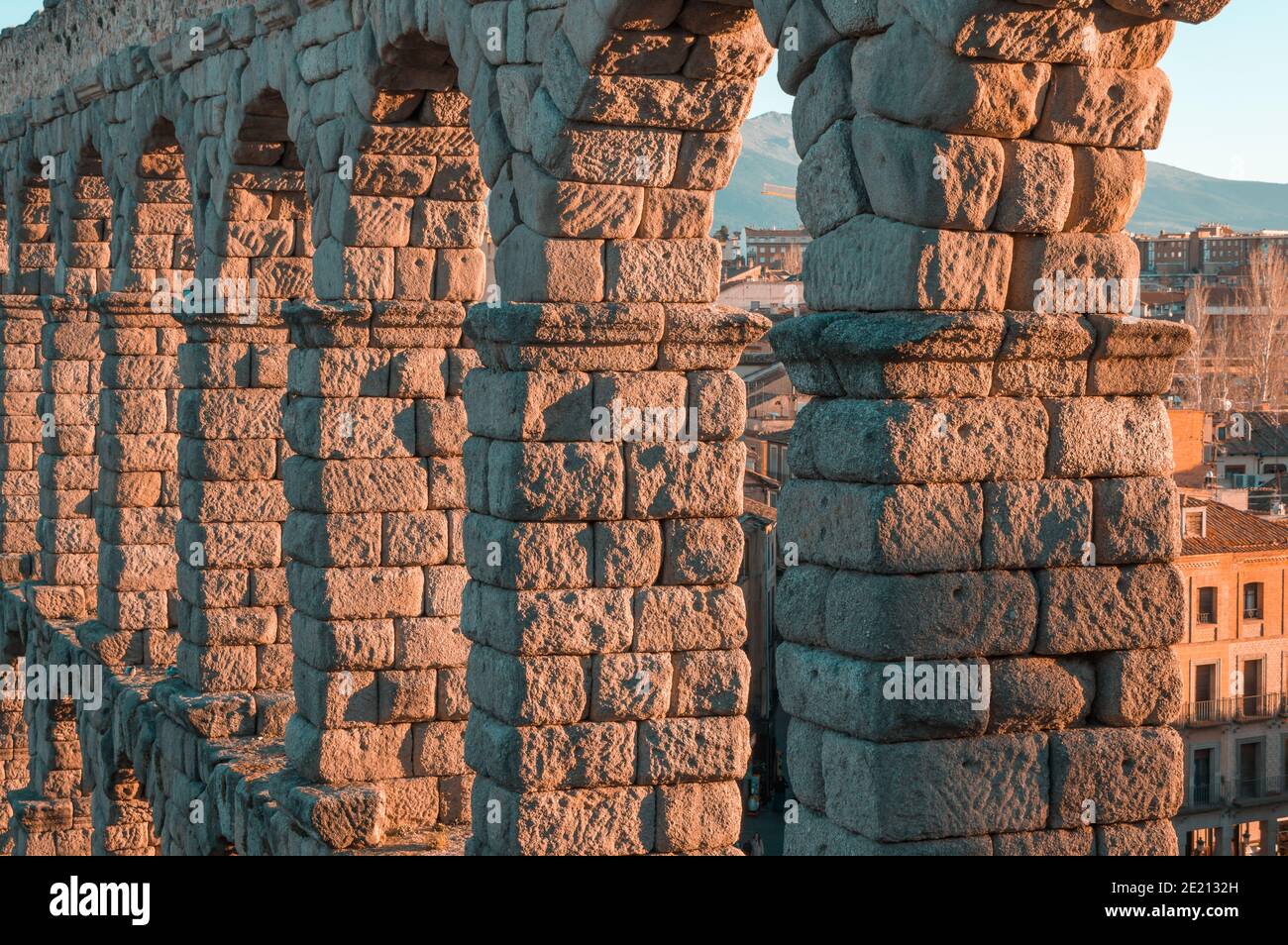 SEGOVIA, SPAIN - Feb 23, 2020: Close-up of the upper arches of the Segovia Aqueduct bathed in the light of a winter afternoon sunset Stock Photo