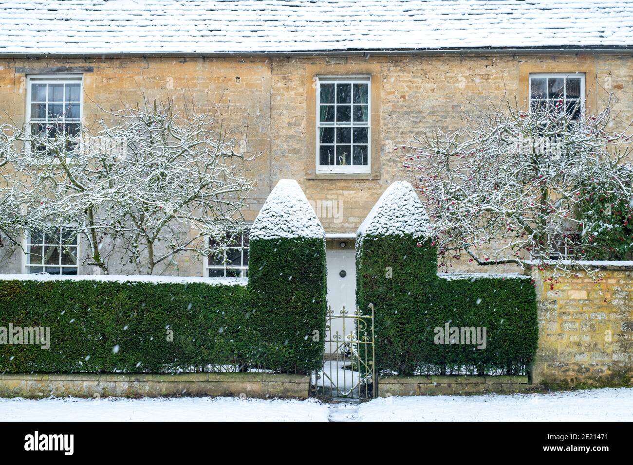 Grand cotswold stone house in the snow at Christmas. Taynton, Cotswolds, Oxfordshire, England Stock Photo
